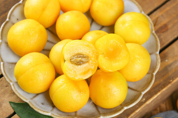 Fresh Golden Apricots in Bowl on Wooden Table - Healthy Organic Stone Fruit