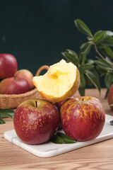 Fresh Red Apples Cut in Half on Wooden Kitchen Counter with Natural Lighting