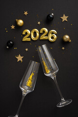 Golden and black vertical decorations, stars, and champagne glasses signify celebration and joy for...