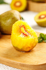 Fresh Yellow Kiwi Fruit with Red Center Cut in Half on Wooden Board - Hongyang Variety Tropical Exotic Healthy Food