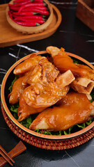 Braised Pork Knuckle and Feet with Soy Sauce Marinade in Bamboo Steamer - Traditional Asian Cuisine
