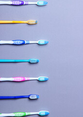 Toothbrushes on a colored background top view. Oral hygiene. Vertical photo format