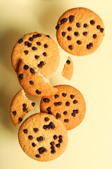 Delicious cookies with chocolate chips on a colored background. Vertical photo format