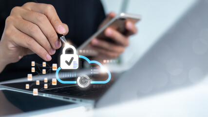 Business person using smartphone and laptop with digital cloud security icon, padlock, and update symbol. Concept for data protection, cybersecurity, and cloud computing safety.