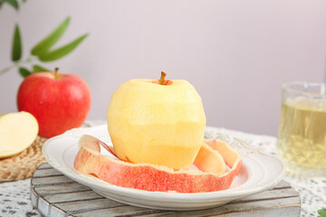 Fresh Peeled Fuji Apple with Red Apple Slices on Plate - Healthy Organic Fruit Snack