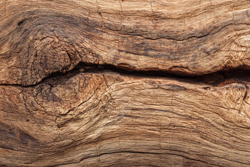 Obraz premium Weathered wood texture showing cracks and grain detail natural brown tones