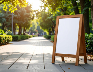 Empty Wooden A-frame Chalkboard Sign on Sidewalk in Sunny Park Scene