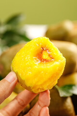 Fresh Yellow Red Heart Kiwi Fruit Slice Held in Hand - Exotic Tropical Produce