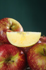 Fresh Red Apples with Water Droplets and Slice on Green Background