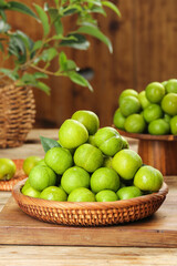 Fresh Green Sichuan Plums in Wicker Basket on Wooden Table - Healthy Organic Fruit Display