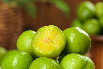 Fresh Green Plums with Golden Flesh - Ripe Stone Fruit Close-up on Wooden Background