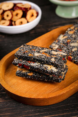 Nutritious Black Sesame Walnut Pastry Bars on Wooden Plate - Healthy Homemade Asian Snack