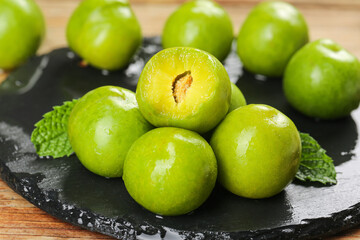 Fresh Green Sichuan Plums with Crisp Flesh on Slate Board - Asian Stone Fruit