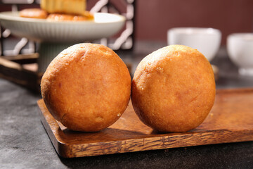 Golden Mooncakes on Wooden Board - Traditional Chinese Pastry for Mid-Autumn Festival Celebration