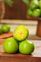 Fresh Green Plums Cut in Half on Wooden Cutting Board - Healthy Organic Fruit