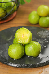 Fresh Sichuan Plums with Crisp Green Skin on Slate Plate - Healthy Asian Fruit