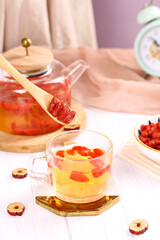 Ningxia Goji Berry Wolfberry Tea with Dried Red Fruit Health Tonic in Glass Cup and Wooden Spoon