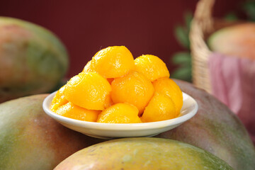 Fresh Golden Mango Chunks in Bowl with Whole Mangoes from Panzhihua China - Premium Tropical Fruit Display