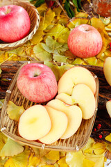 Fresh Red Fuji Apples from Yantai Shanxi in Wicker Baskets with Autumn Leaves Background