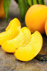 Fresh Sweet Yellow Peach Slices and Whole Fruit on Rustic Wood Surface