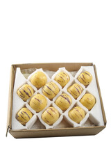 Yellow Pepino Melons with Purple Stripes Packed in Cardboard Box for Fresh Fruit Distribution