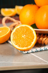 Fresh Holland Oranges Sliced on Kitchen Counter with Honey Dipper - Healthy Citrus Fruits and Natural Ingredients