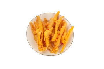 Pickled chicken feet with spicy pepper sauce on white plate - traditional Asian food delicacy