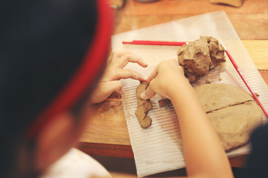Child Enjoying Pottery Class. Creative Learning for Kids.