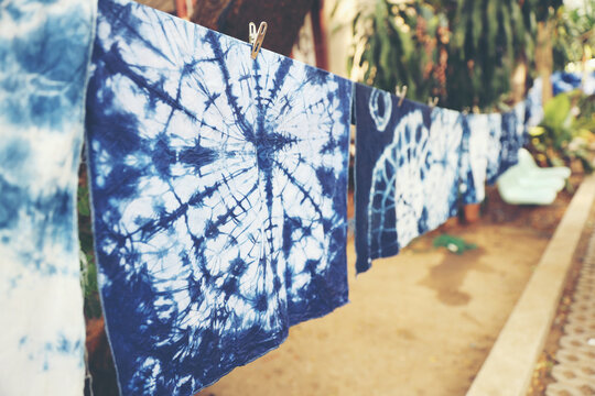 Handmade Indigo Tie-Dye Fabrics. Artisanal Tie-Dye Cloth Drying in the Sun. Natural Indigo Dyeing Process