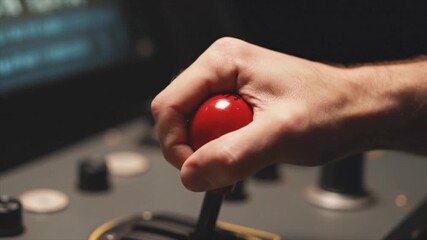 Hand gripping red joystick on dark background. Suitable for gaming, technology, control, and entertainment concepts in design projects. - Powered by Adobe