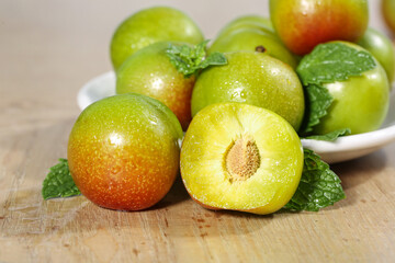 Fresh Green Plums on Wooden Cutting Board - Healthy Organic Stone Fruit Display