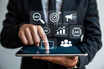 Business professional using digital tablet interacting with marketing and seo icons interface