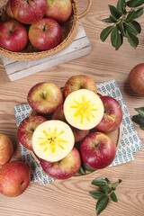 Fresh Red Apples Cut and Whole with Star Pattern in Rustic Kitchen Setting