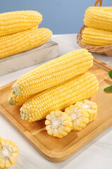 Fresh Sweet Corn on the Cob - Yellow Vegetables on Wooden Cutting Board with Basket