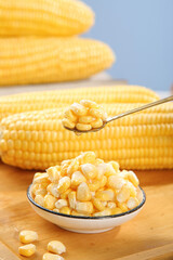 Fresh Sweet Yellow Corn Kernels in Bowl with Corn Cobs on Wood Cutting Board
