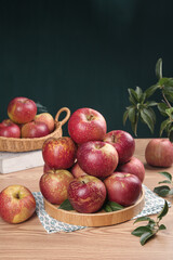 Fresh Red Apples from Daliang Mountain Region on Rustic Wooden Table with Natural Kitchen Setting