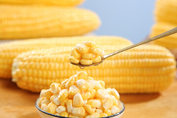 Fresh Yellow Corn Kernels on Spoon with Corn Cobs - Healthy Vegetable Food Concept