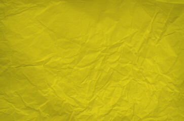 Yellow crumpled paper background Crumpled sheet of yellow paper close up. Detailed photo textured background unique texture depth, illuminated by soft, natural light, creating shadows Copy space 