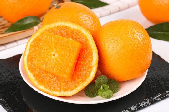 Fresh Orange Citrus Fruits with Mint on White Plate - Healthy Natural Food Photography - Powered by Adobe