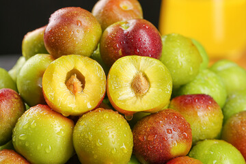 Fresh Cut Plums with Water Droplets Showing Yellow Flesh and Pit - Healthy Organic Stone Fruit