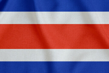 flag of the Republic of Costa Rica with horizontal stripes on a rough canvas with folds
