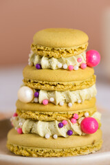 Christmas tree macaroons with cream and candies, closeup. Vertical orientation.