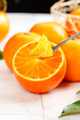 Freshly picked Ehime orange jelly on spoon with sliced citrus fruits - homemade marmalade preparation