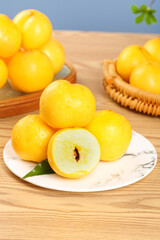 Freshly Picked Golden Peaches on White Plate with Wicker Basket Display