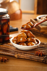 Tangy Pickled Olives in Bowl with Garlic Sauce - Traditional Mediterranean Side Dish on Rustic Wooden Background