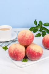 Fresh Shandong Yingshanghong Peaches on Marble Board with Tea Cup - Premium Winter Red Fruit Display