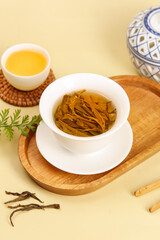 Freshly Brewed Longjing Green Tea with Leaves in Traditional Chinese Tea Ceremony Setup