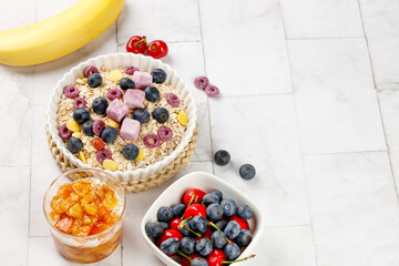 Healthy oatmeal breakfast bowl with berries yogurt chunks and banana for fat loss diet nutrition