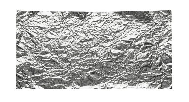 The reflective surface of crumpled aluminum foil shining like a forgotten memory in stark black and