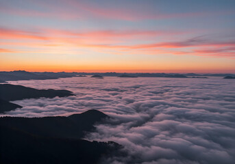 Fototapeta premium Clouds over mountains at sunset.